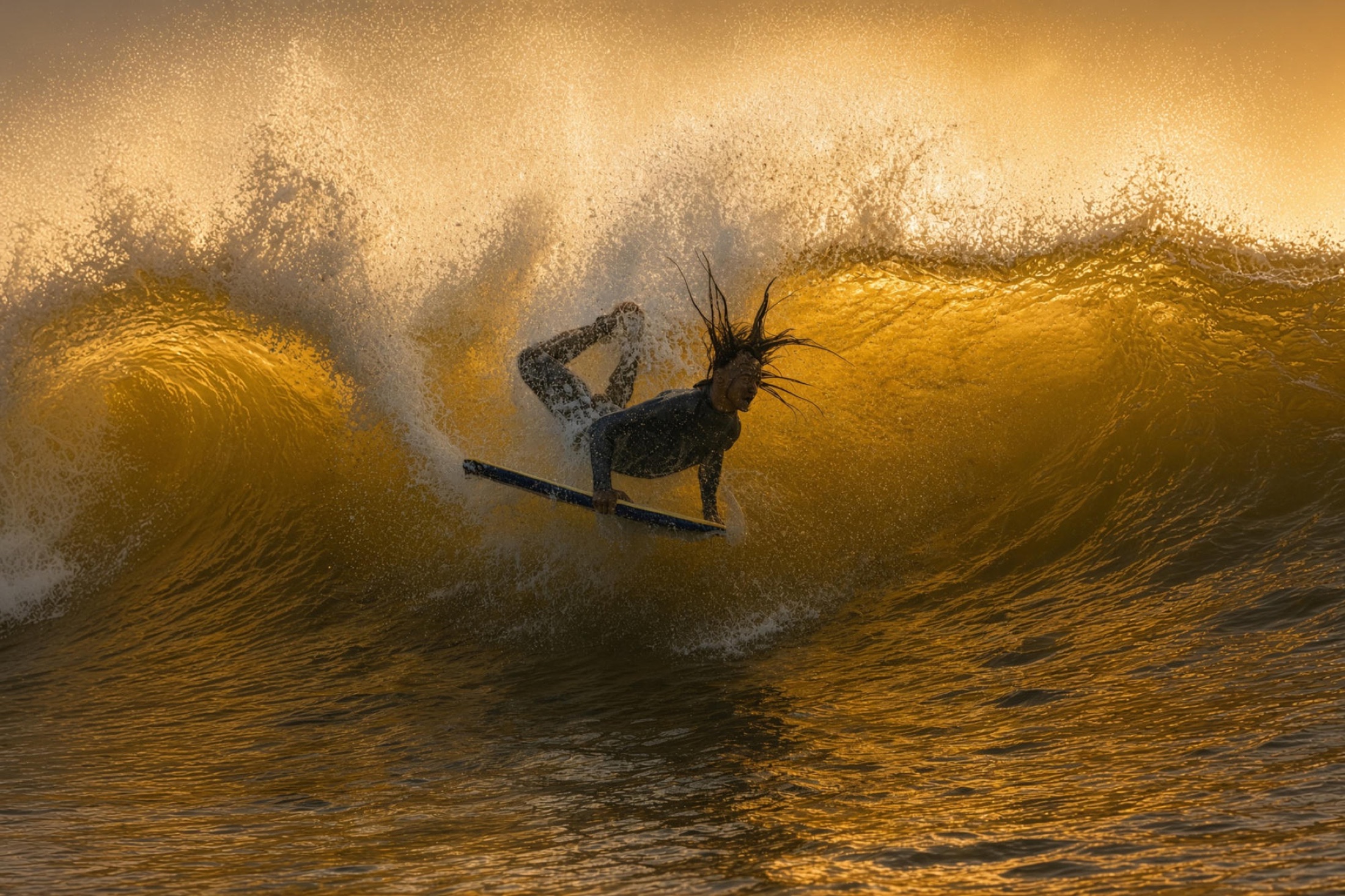 Surfer inside a breaking wave
